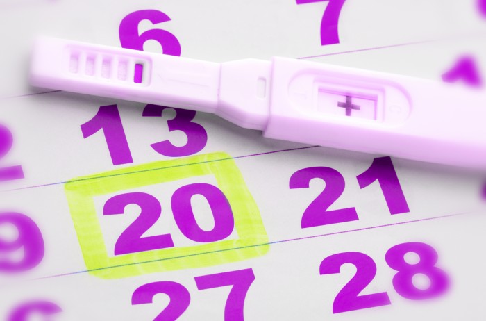 Positive pregnancy test on calendar page