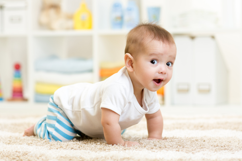 crawling funny baby boy indoors at home