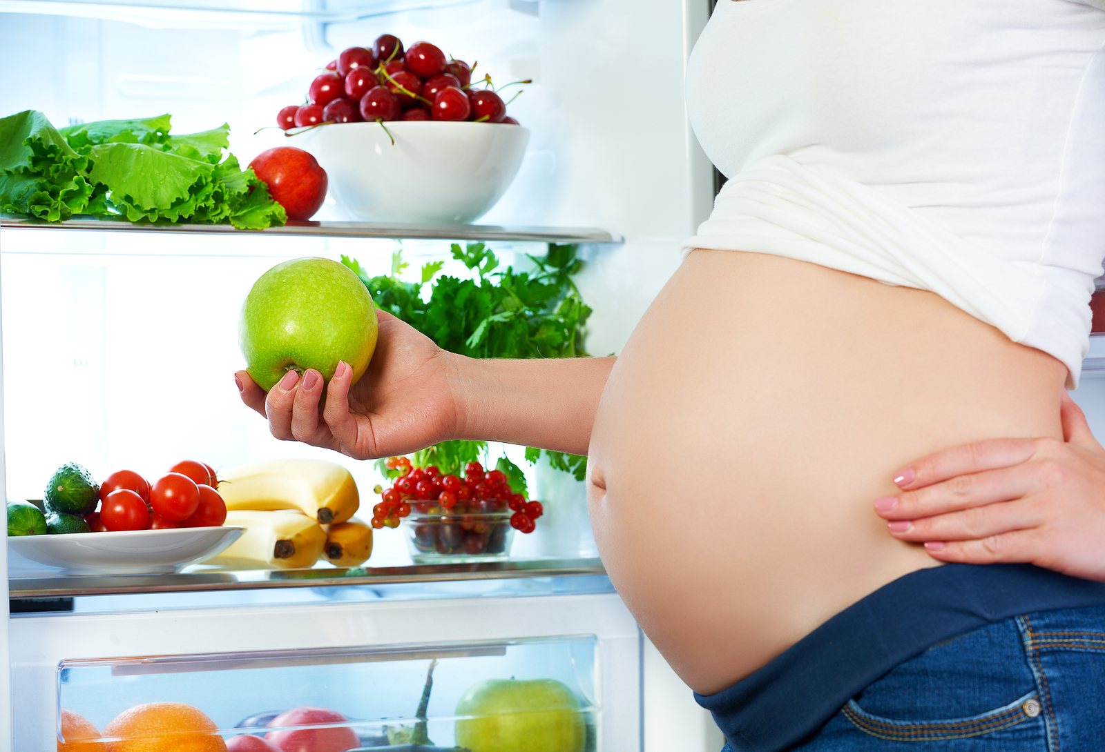 Nutrition And Diet During Pregnancy. Pregnant Woman With Fruits