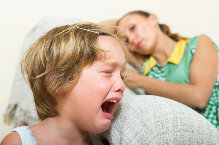 Crying child and mother at home