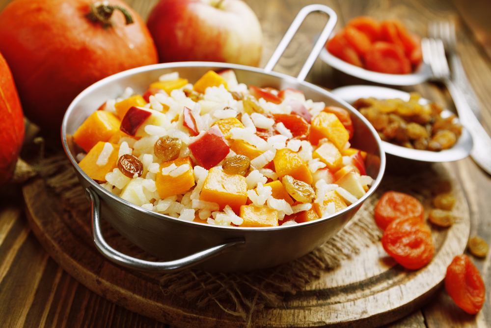 Sweet pilaf with pumpkin, apples and dried fruit on the table